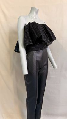 the mannequin is wearing black leather pants and a black top