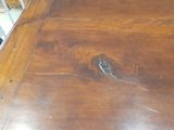a wooden table with a bird on top of it