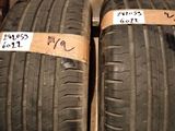 two tires with labels on them are sitting on the floor