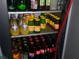 many bottles of alcohol and a hose on the shelf