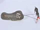 a figurine of a person pulling a dog on a leash