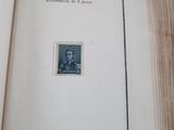 an open book with a stamp on it sitting on a table