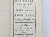 an open book on a white surface with a black border