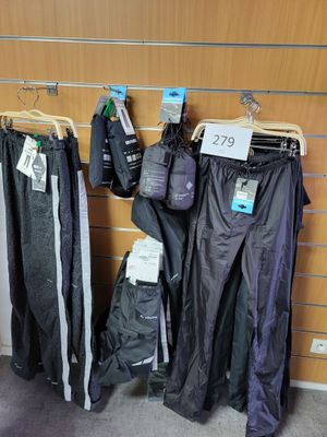 many pairs of pants hanging on a rack in a store