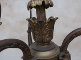 a close up of a chandelier with a bird on it