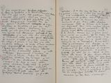 an open book with a handwritten page on it sitting on top of a table