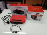 a red box on the table next to a black box on the table