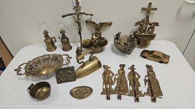 a table with a lot of brass items on it
