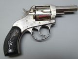 an old revolver with a wooden handle on a white surface