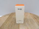 the box of balzac is sitting on a wooden table