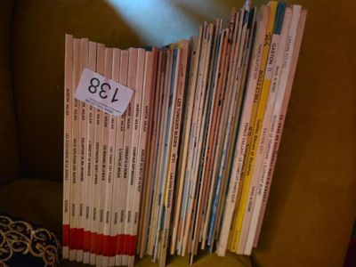 a pile of books sitting on a chair with a price tag on it