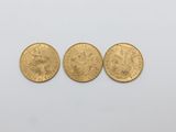 three gold sovereigns, one of which is a sovereign and one of which is a sovereign