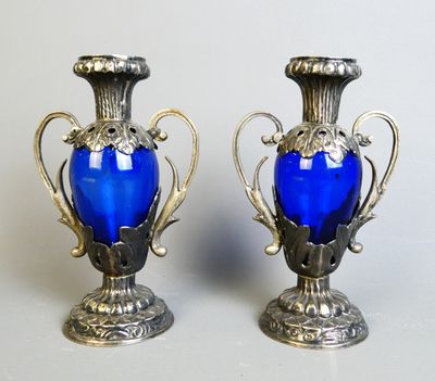 two blue vases sitting next to each other on a table