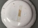 a close up of a white plate with a tag on it