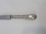 a knife that is laying on a white surface