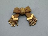 an image of a pair of gold toned earrings with tassels
