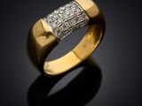 a close up of a gold and diamond ring on a black surface