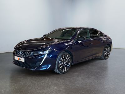 a blue car parked in a room with a white wall