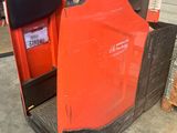 a forklift with a red cover sitting in a garage