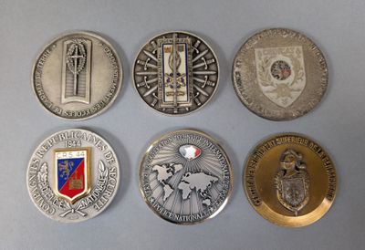several coins are arranged in a row on a gray surface