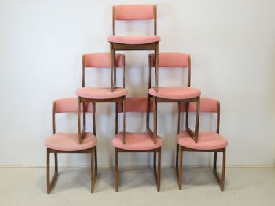 six pink chairs stacked on top of each other