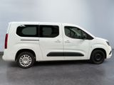 the white van is parked in a room with a gray floor