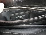 the inside of a saint laurent bag with a hand holding it