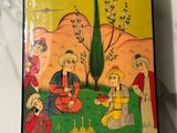 painting of a group of people sitting on a grass covered ground