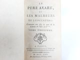 an old book that is open on a table