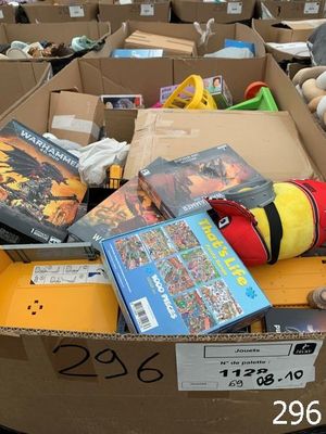 a cardboard box full of toys and books for sale