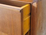 a close up of a wooden dresser with a drawer