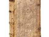 an old book sitting on top of a white surface