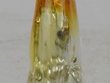 a glass gnome figurine sitting on a white surface