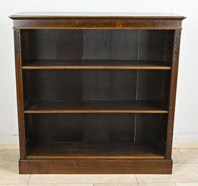 an old wooden bookcase with three shelves on the top