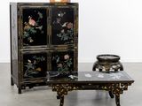 a table with a vase and a cabinet with flowers on it