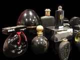 many different types of perfume bottles on a black background