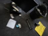 a black trash can sitting on the floor next to a computer