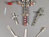 a lot of spoons and a cross on the table