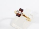 an image of a gold ring with garnets and diamonds