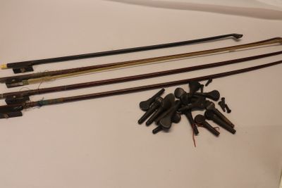 four different types of fishing rods on a white surface