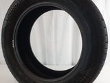a close up of a tire on a white surface with a curtain in the background