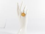 a white mannequin hand with a gold ring on it