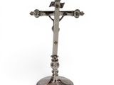 silver plated crucift with a cross on top of it