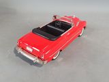 a red toy car that is sitting on the floor