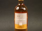 a bottle of wine sitting on top of a black table