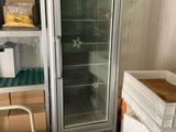 a refrigerator that is next to a stack of boxes in a room