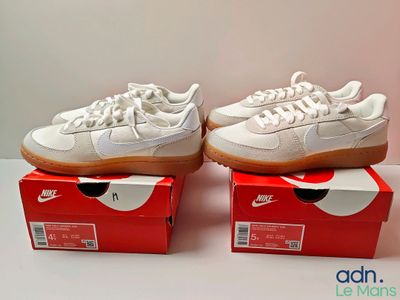 pair of white nike sneakers sitting on top of a red box