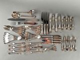 a lot of silver spoons and forks on the table