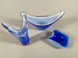a blue glass bowl and a blue bowl on a table