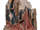 an old statue of a man sitting on a rock with a dog